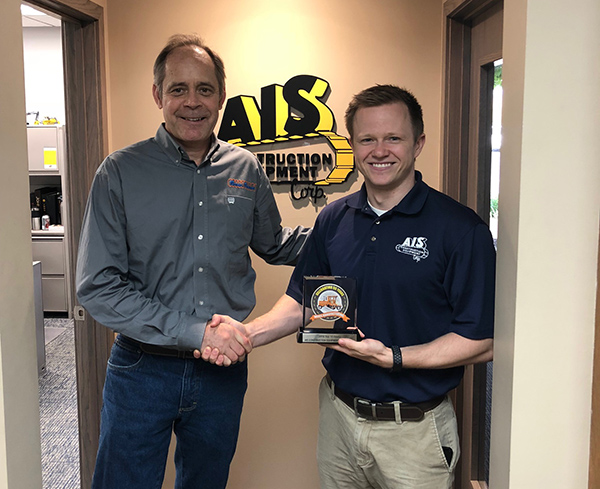 Evan Lowery, Inventory Manager of AIS Equipment pictured with Broce Sales Rep Dave Krason, accepting their top 10 dealer award.